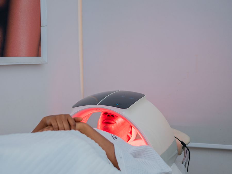 Red LED light therapy facial treatment in a modern beauty studio